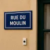 Plaque de rue allongée — façade d'une maison de bourg